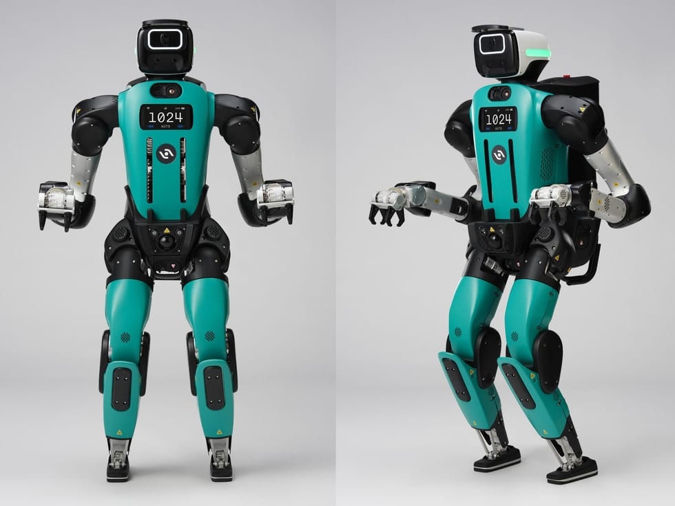 A front and an angled view of a teal-colored humanoid robot with arms bent at the elbow.