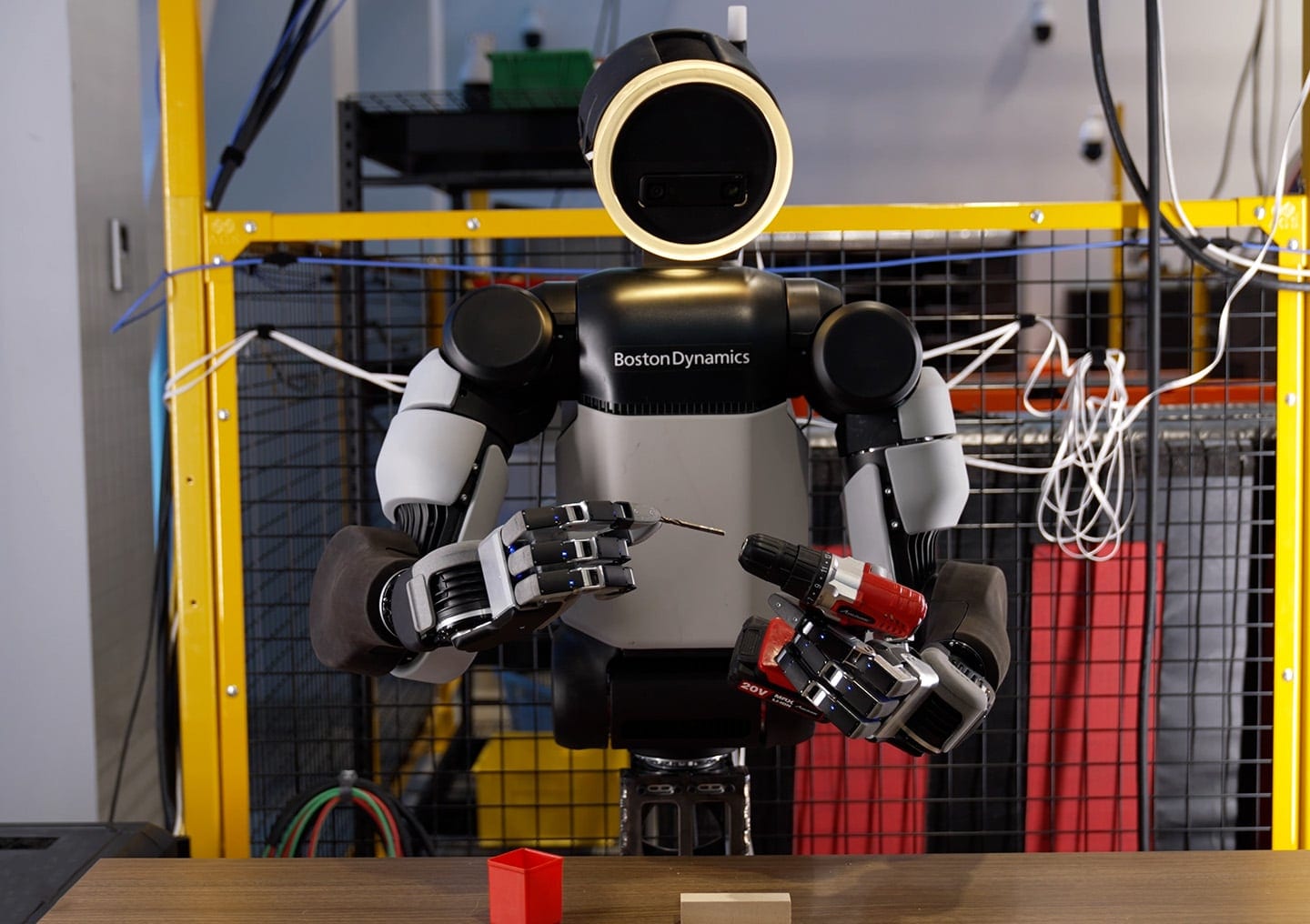 An Atlas robot places a drill bit into a drill