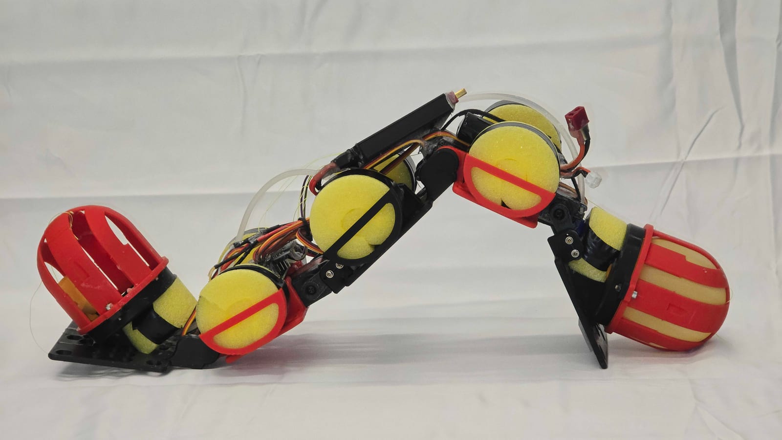Undulatory robot shifts water to climb 19.5-degree slopes